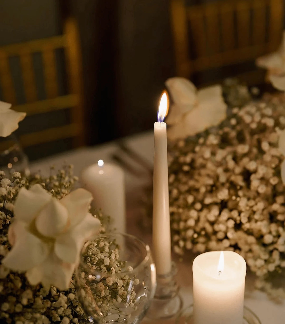 Intimate wedding candle arrangement with soft florals creating a warm ambiance