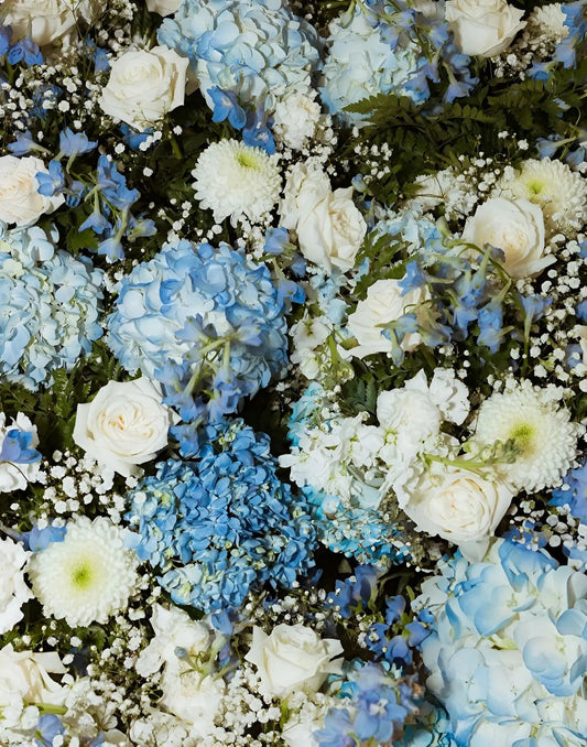 Close-up of a floral arrangement with blue and white flowers.
