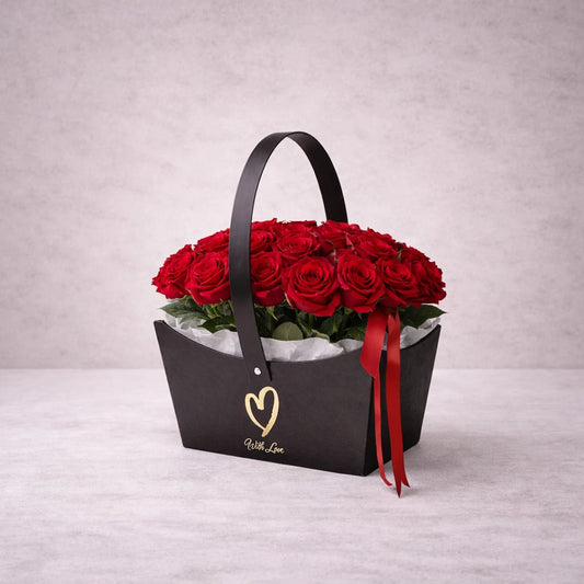Black handbag filled with red roses on a light gray background
