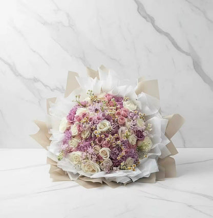 Bouquet of flowers wrapped in paper on a white background