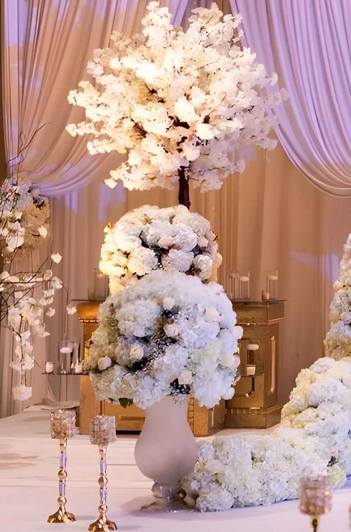 Decorative floral arrangement with white flowers and lights in a formal setting.