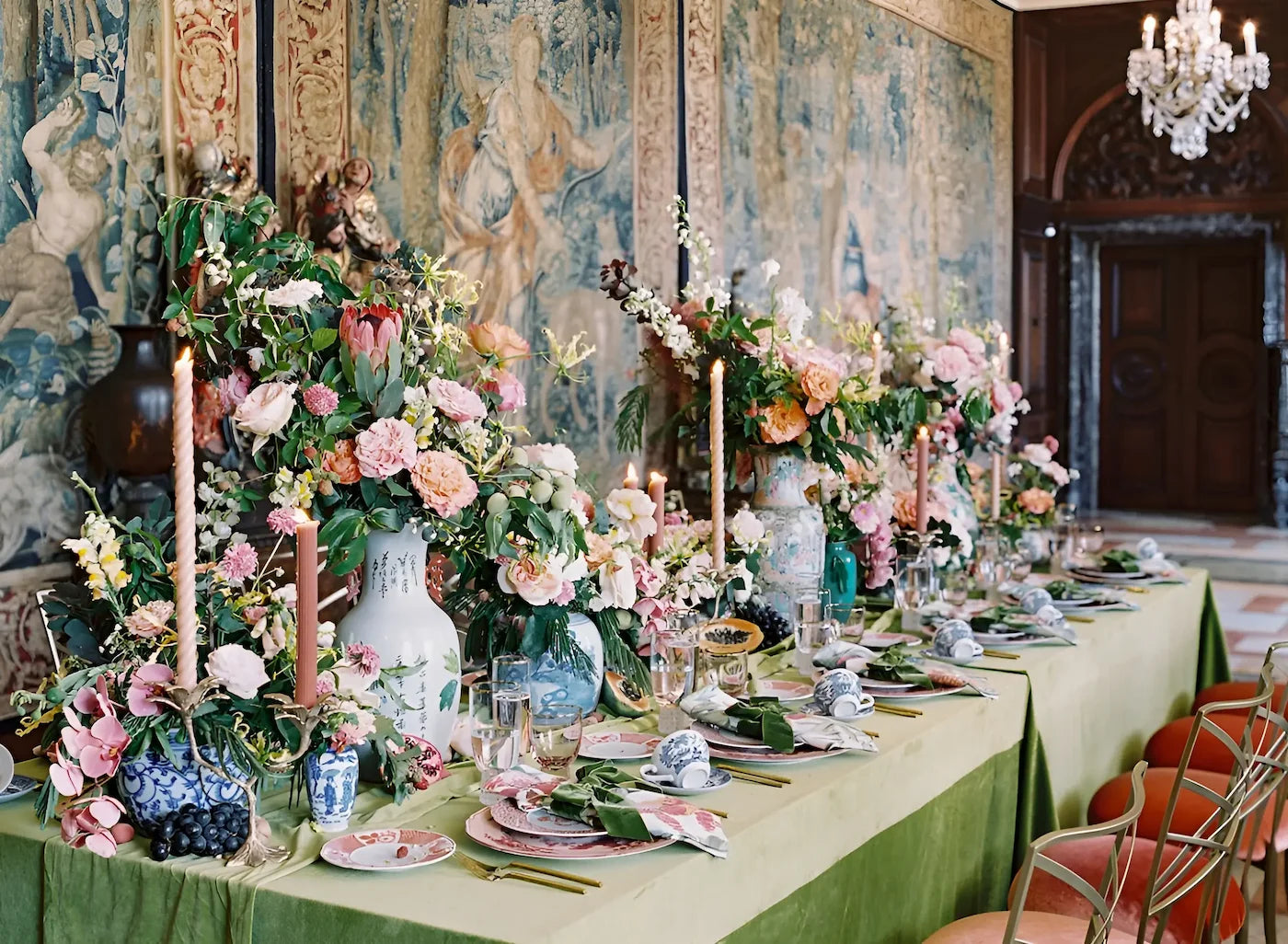 Elegant table setting with lush floral arrangements and candles at a wedding reception in Ann Arbor, Michigan.